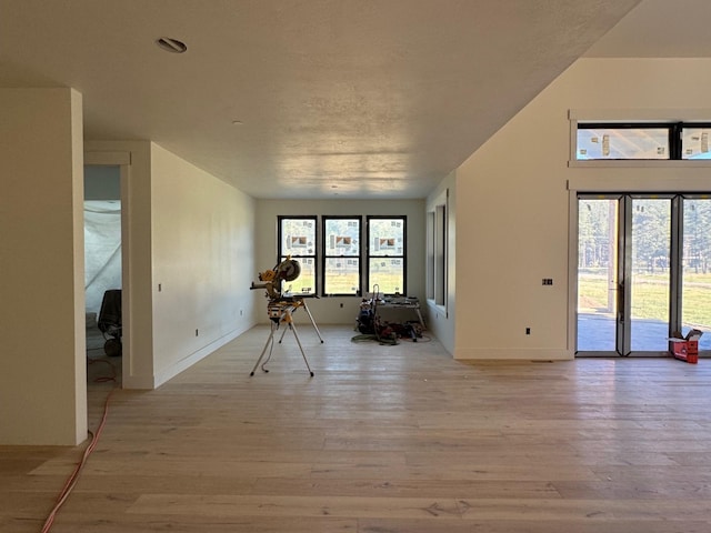 unfurnished room featuring light wood-type flooring and baseboards