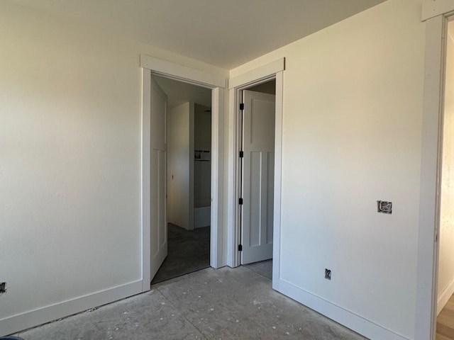9883 Hatton Ln, Lolo, MT 59847 - unfurnished bedroom featuring baseboards and concrete flooring
