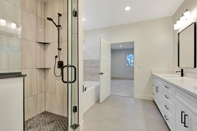 bathroom with vanity and separate shower and tub