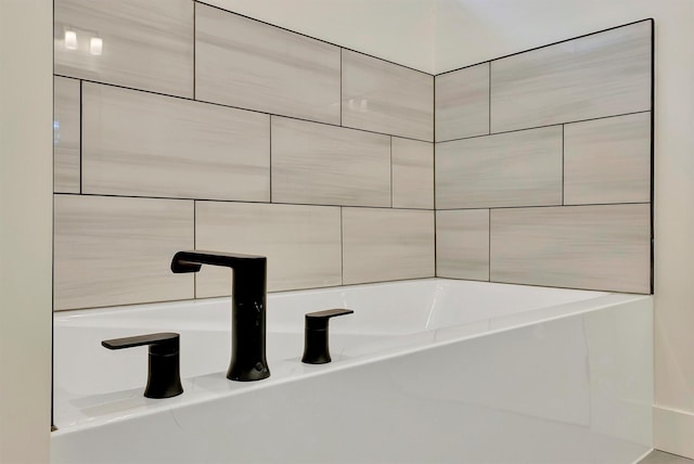 bathroom with sink and a tub