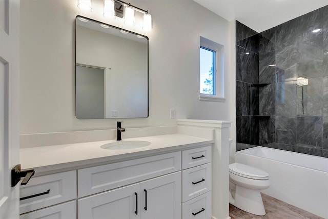 full bathroom with vanity, tiled shower / bath, hardwood / wood-style flooring, and toilet