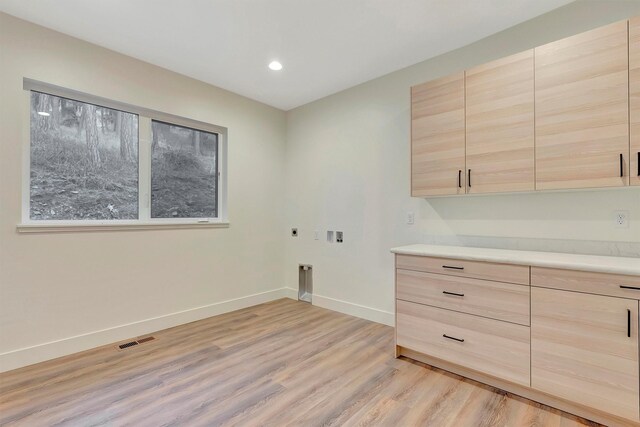 unfurnished room with light hardwood / wood-style floors