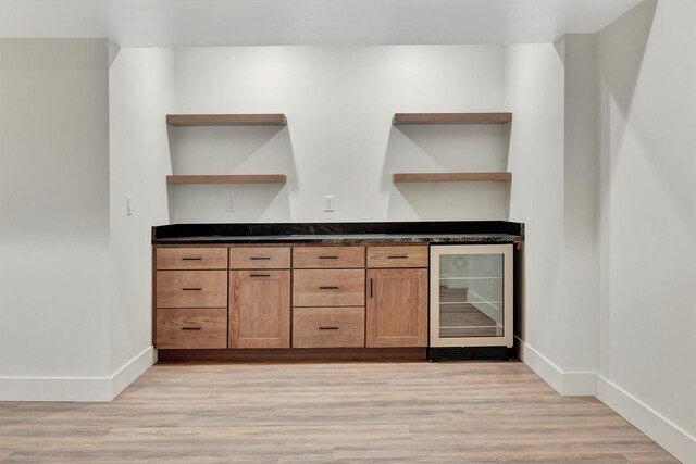 bar featuring light hardwood / wood-style flooring and wine cooler