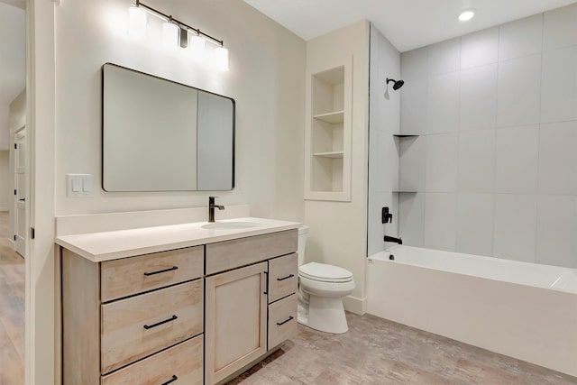 full bathroom with vanity, tiled shower / bath, wood-type flooring, and toilet