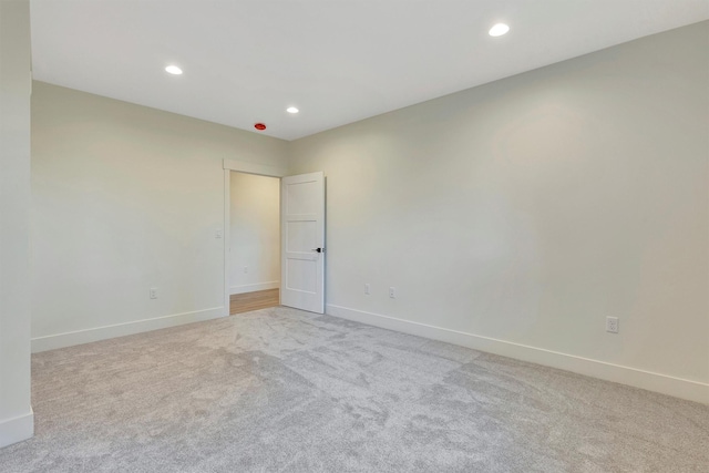 unfurnished room with light colored carpet