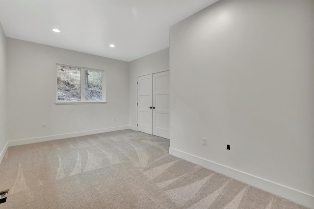 unfurnished bedroom featuring light carpet