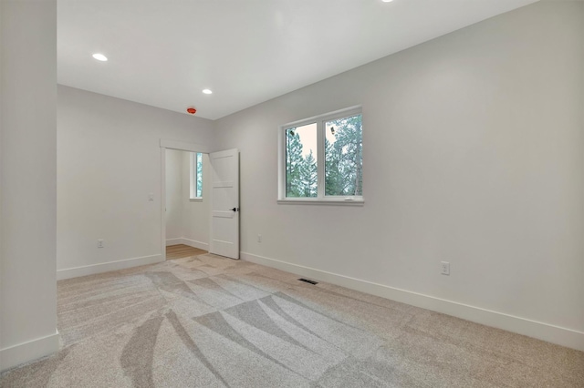 unfurnished room with light carpet