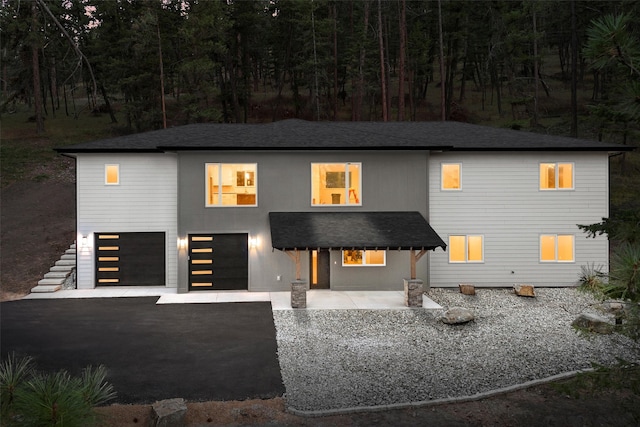 view of front of home featuring a garage and a patio