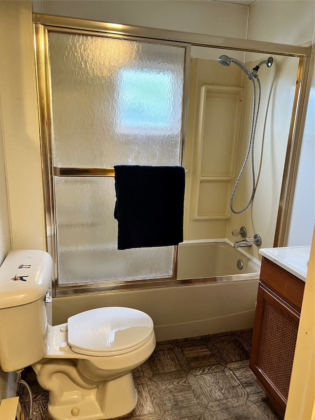 full bathroom with shower / bath combination with glass door, vanity, and toilet