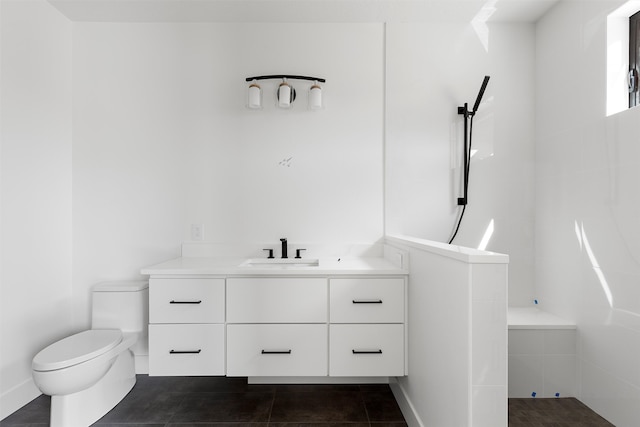 bathroom featuring tile patterned flooring, toilet, and vanity