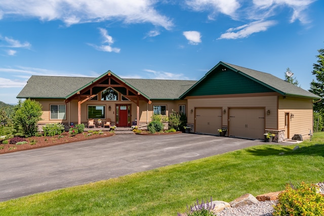 craftsman inspired home with a garage and a front lawn