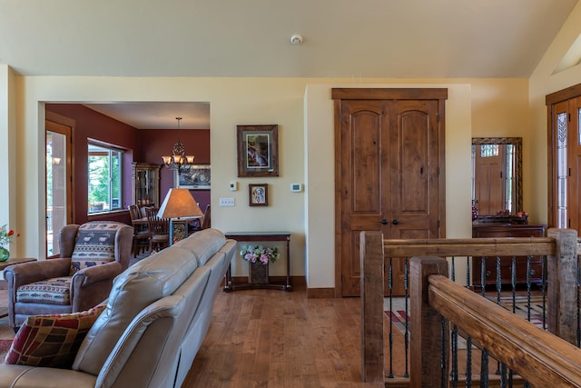 living room with hardwood / wood-style flooring and a chandelier