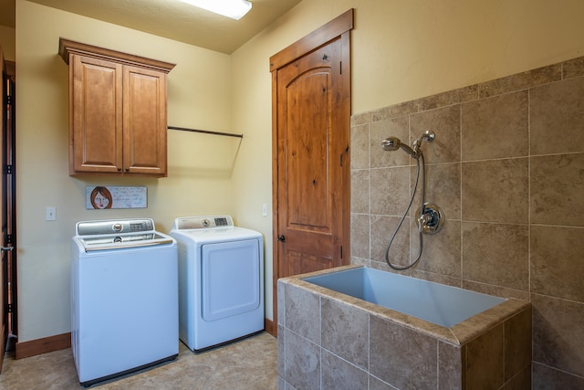 washroom with washer and clothes dryer and light tile patterned flooring