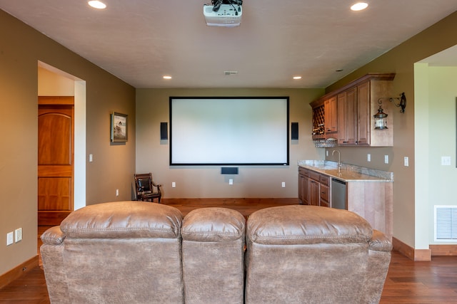 cinema with dark hardwood / wood-style floors and sink