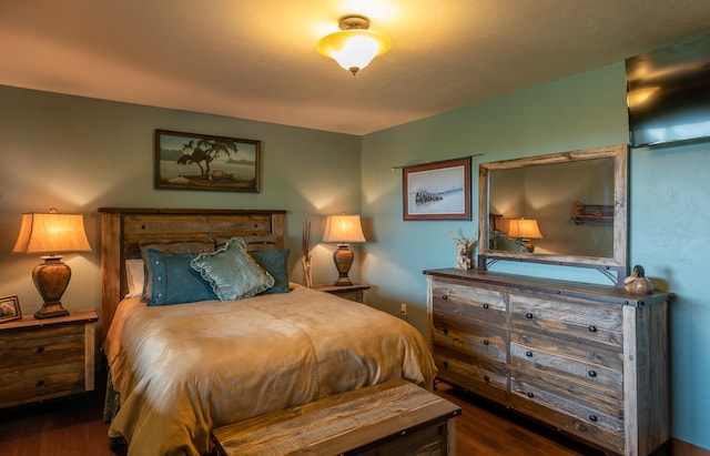 bedroom with dark hardwood / wood-style floors