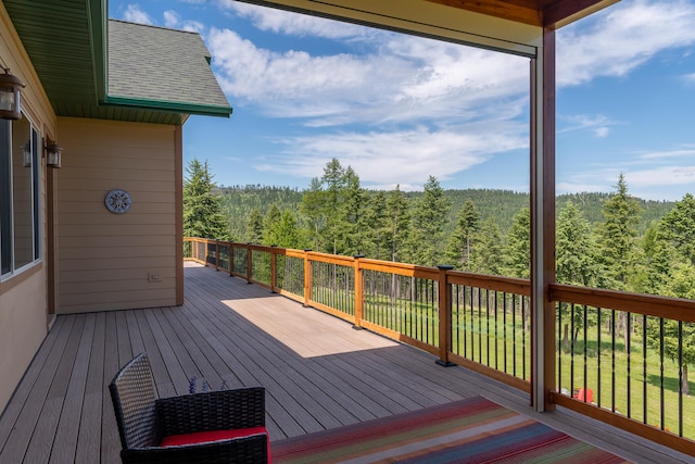 wooden terrace featuring a yard