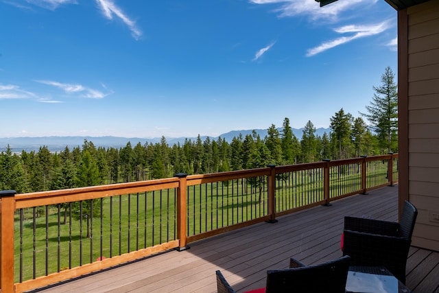 wooden terrace with a yard