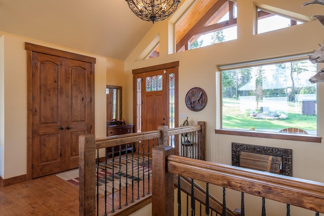 entrance foyer featuring hardwood / wood-style floors and high vaulted ceiling