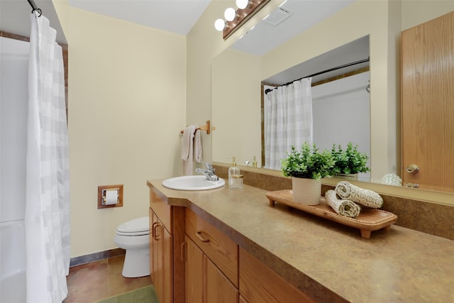 bathroom featuring vanity, tile patterned floors, and toilet