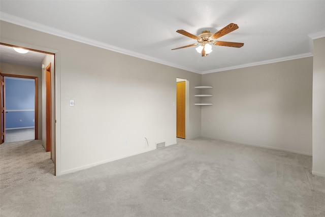 carpeted empty room featuring ornamental molding and ceiling fan