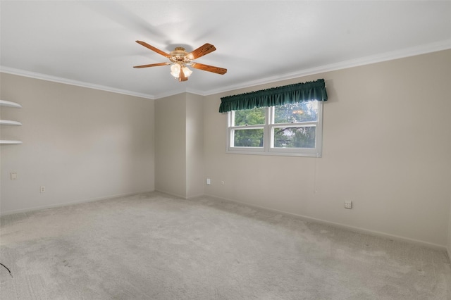 carpeted empty room with crown molding and ceiling fan