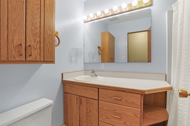 bathroom with vanity and toilet