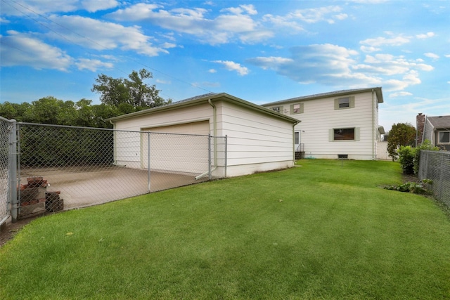 back of property with a garage and a lawn