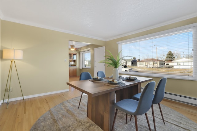 office space featuring ornamental molding, a textured ceiling, light wood-type flooring, and a baseboard radiator