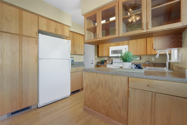 kitchen featuring white appliances, light brown cabinetry, sink, and light hardwood / wood-style flooring