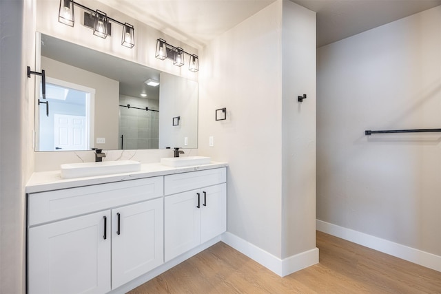 bathroom featuring vanity, hardwood / wood-style floors, and walk in shower