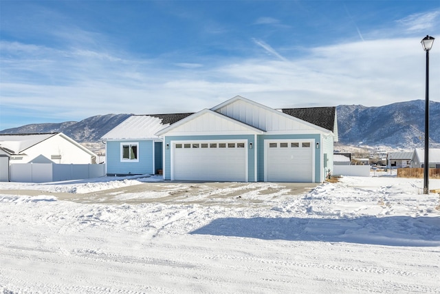 view of front facade featuring a garage and a mountain view