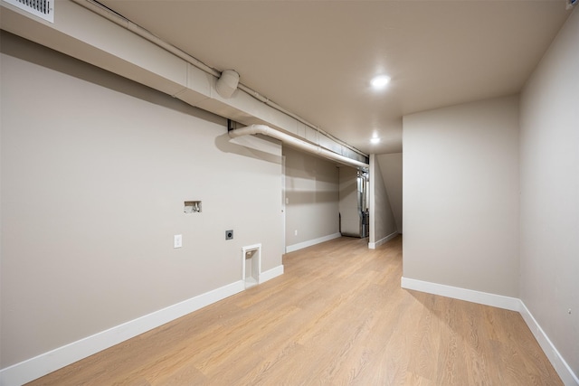 clothes washing area with light hardwood / wood-style floors, hookup for an electric dryer, and hookup for a washing machine