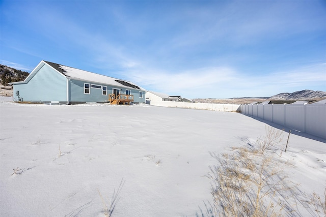 snowy yard with a wooden deck