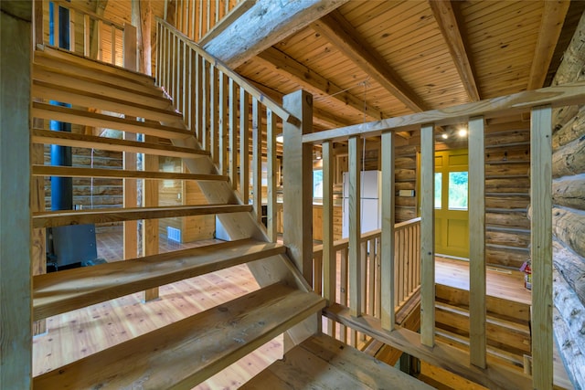 stairs with wooden ceiling, hardwood / wood-style flooring, and beam ceiling