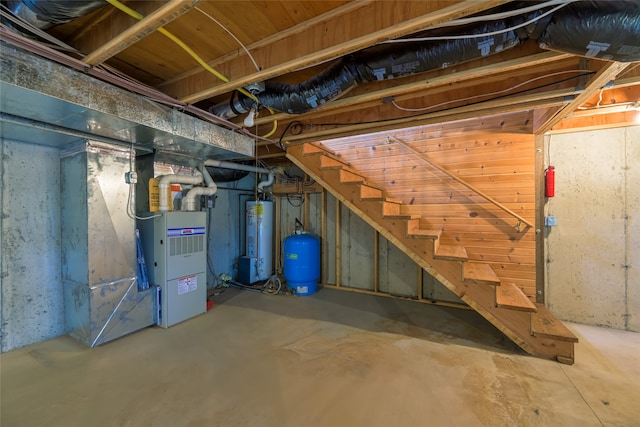 basement featuring heating unit and water heater