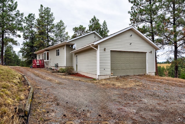 view of side of home featuring a garage and an outdoor structure