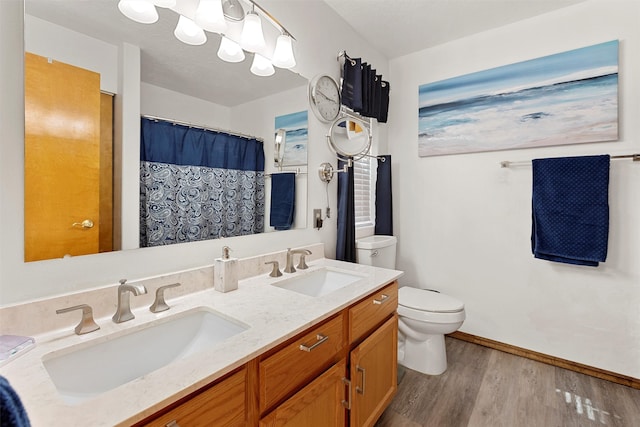 bathroom with vanity, toilet, a shower with shower curtain, and hardwood / wood-style floors