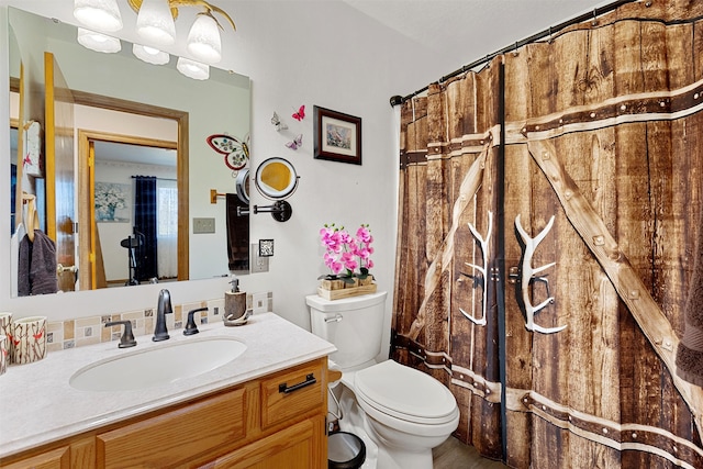 bathroom featuring curtained shower, toilet, and vanity