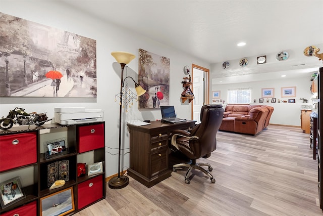 office area with light hardwood / wood-style floors