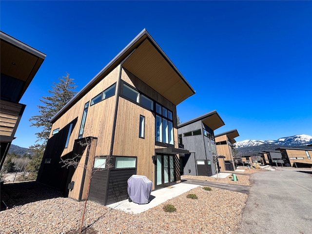 view of home's exterior featuring a mountain view and a patio