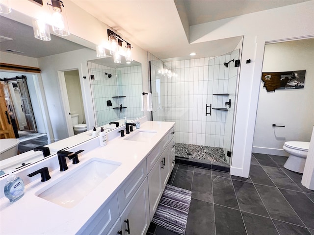 bathroom featuring tile patterned flooring, toilet, a tile shower, and vanity