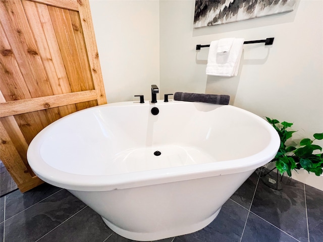 bathroom featuring tile patterned flooring and a washtub