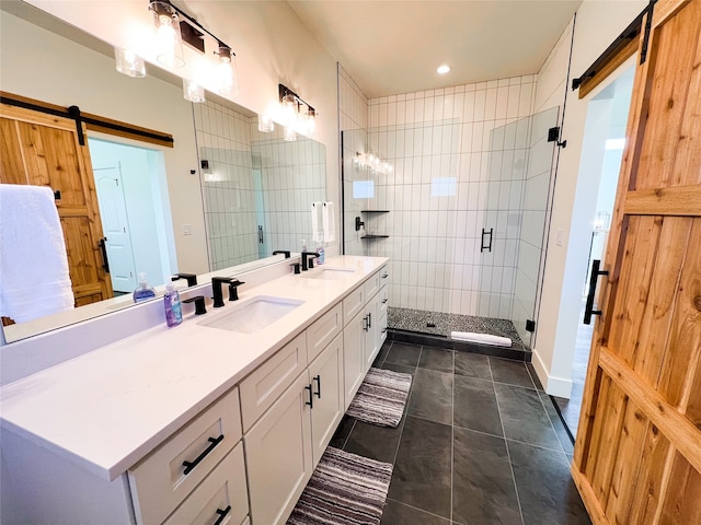 bathroom featuring tile patterned flooring, a shower with door, and vanity