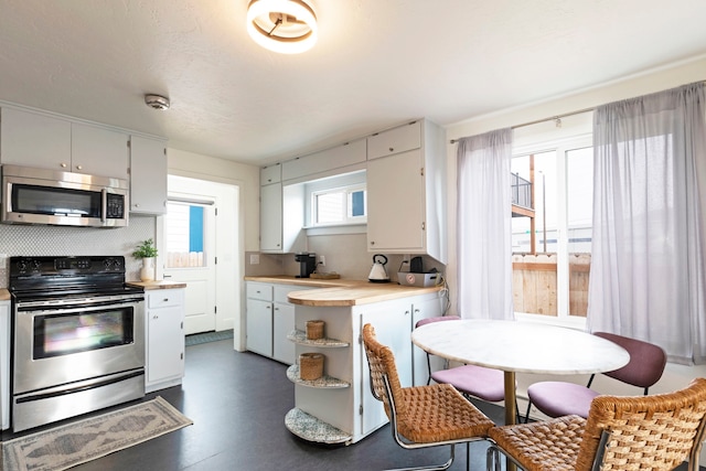 kitchen with appliances with stainless steel finishes and white cabinetry