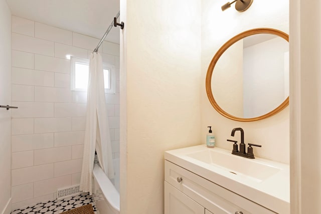 bathroom with shower / bath combo, tile patterned flooring, and vanity