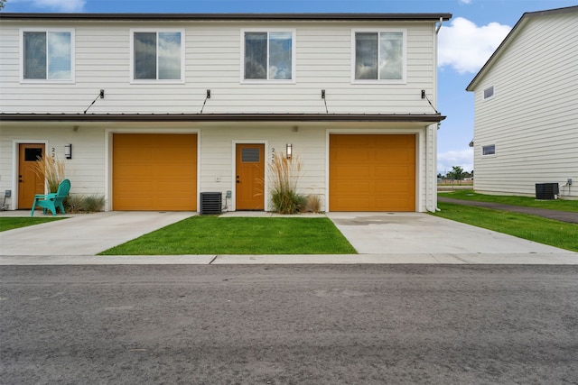 view of front facade with a garage and central air condition unit