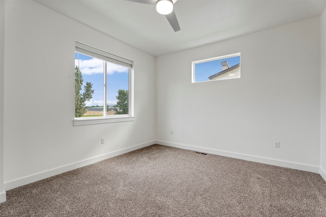 carpeted empty room featuring ceiling fan