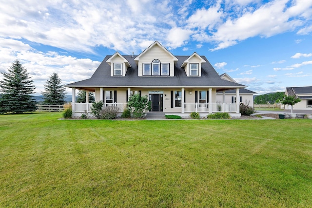 farmhouse inspired home with a front yard and covered porch