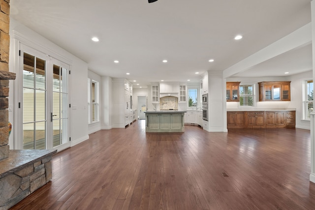 unfurnished living room featuring a fireplace and dark wood-type flooring