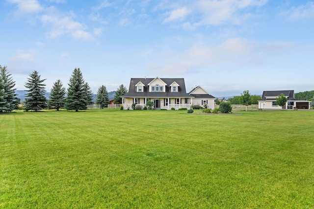 new england style home featuring a front lawn